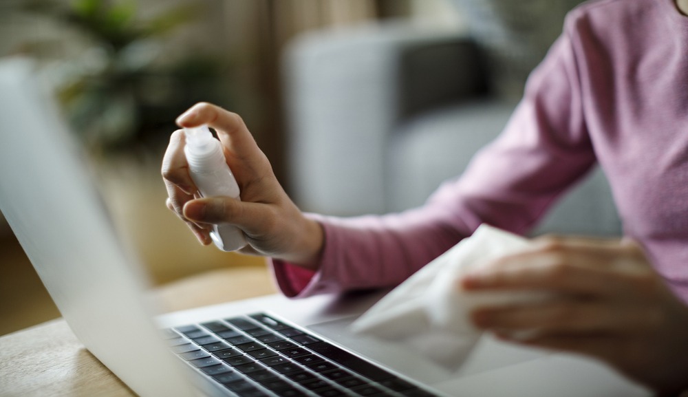 Linda Walmsley discusses the value of spring cleaning your CV. Image shows her cleaning a laptop screen
