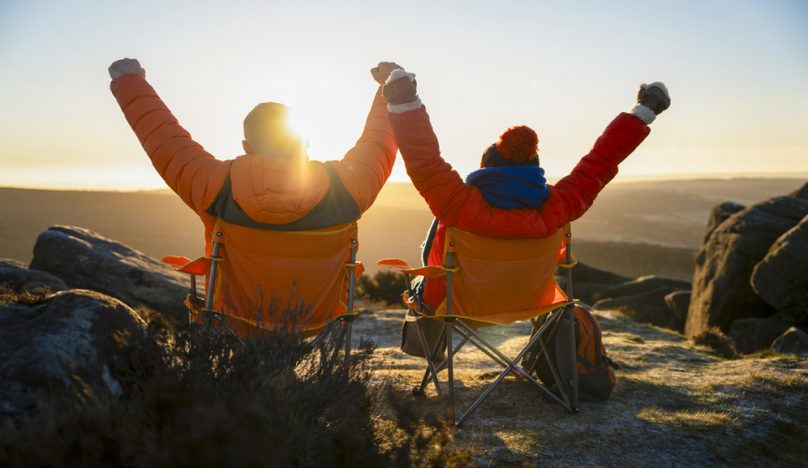 Male and female executives celebrating life whilst exploring the landscape and watching a sunrise whilst on a work sabbatical