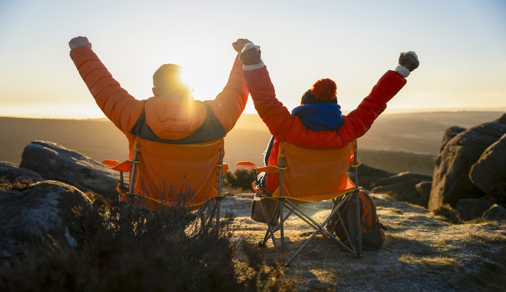 Male and female executives celebrating life whilst exploring the landscape and watching a sunrise whilst on a work sabbatical